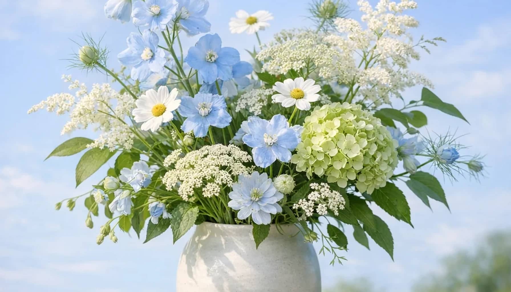 International Day of Clean Air for Blue Skies flower arrangement with seasonal wildflowers, green hydrangea, textural foliage designed as a respectful nature and sustainability floral guide