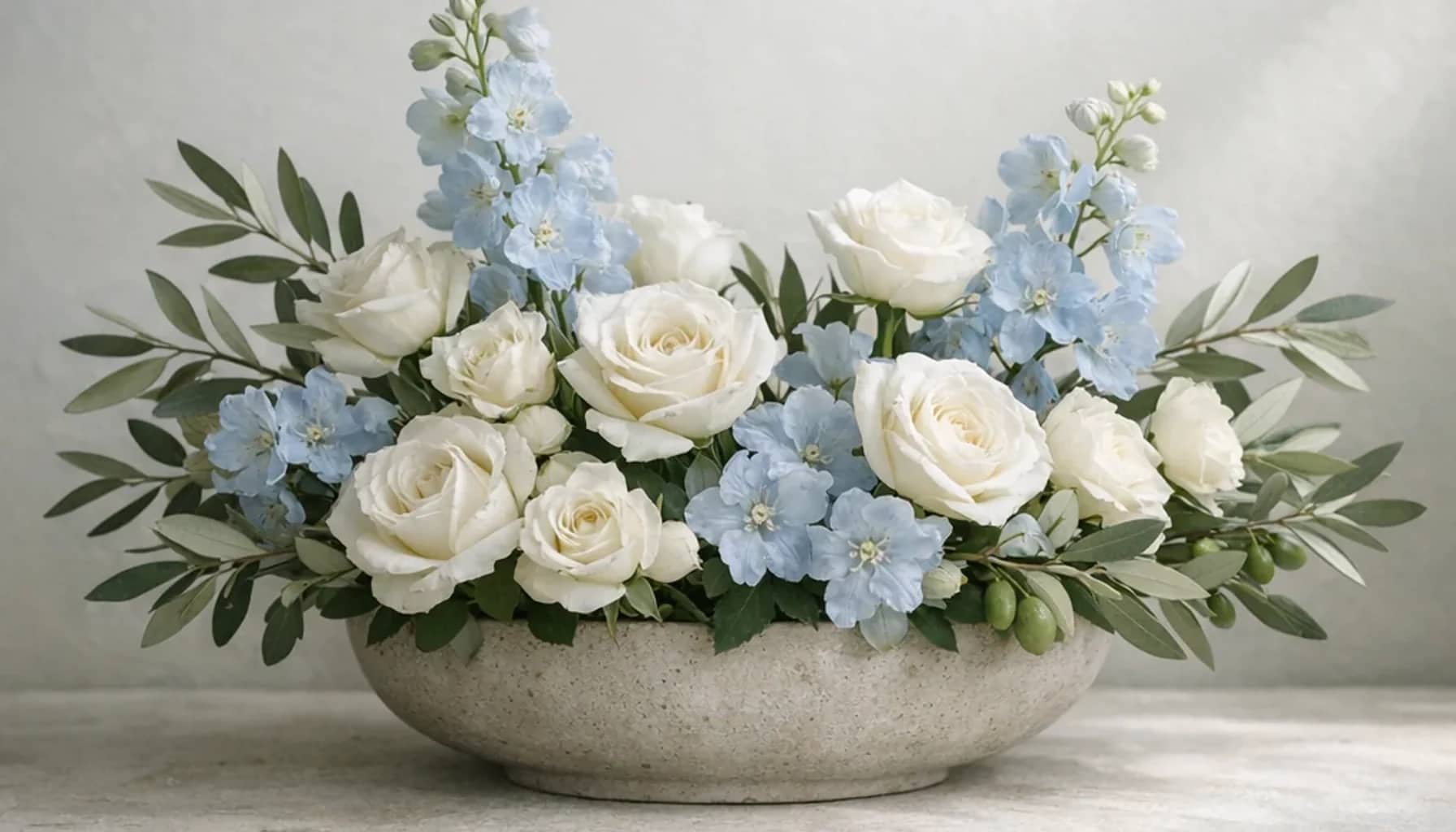 Human Rights Day flower arrangement with white roses, olive branches, pale blue delphinium designed as a respectful peace and solidarity floral guide
