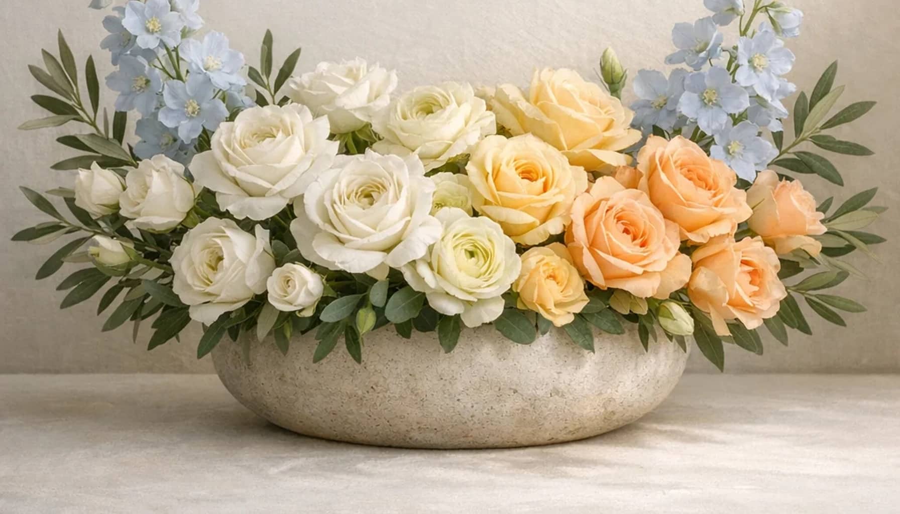 International Day of Hope flower arrangement with white roses, olive branches, pale blue delphinium designed as a respectful peace and solidarity floral guide