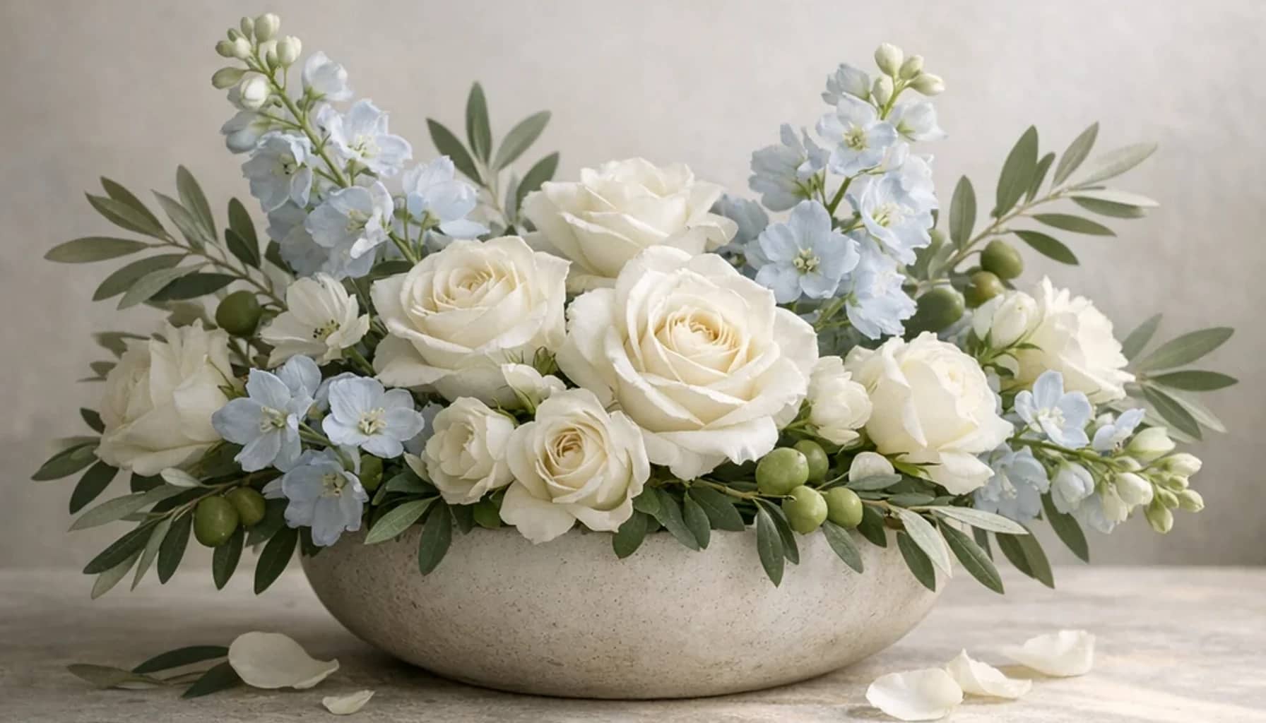 International Day of Human Fraternity flower arrangement with white roses, olive branches, pale blue delphinium designed as a respectful peace and solidarity floral guide