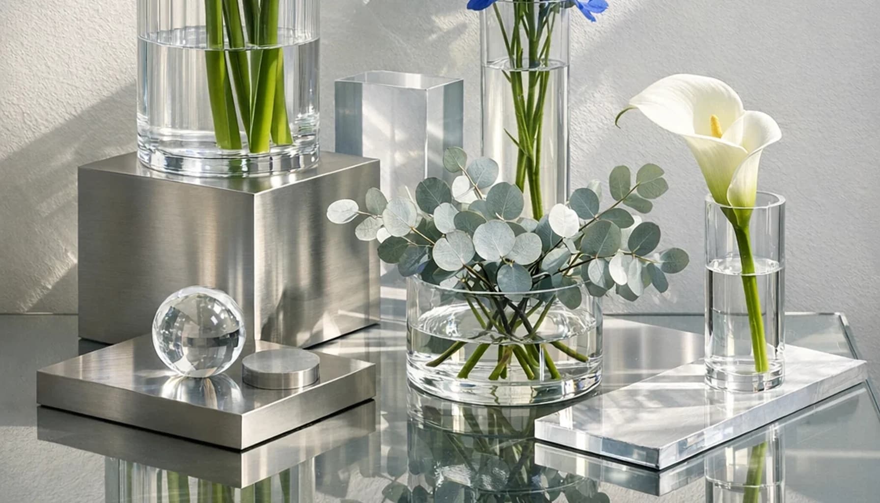 International Day of Light flower guide banner featuring white calla lilies, blue delphinium, silver eucalyptus in optic white, cobalt, silver, green tones