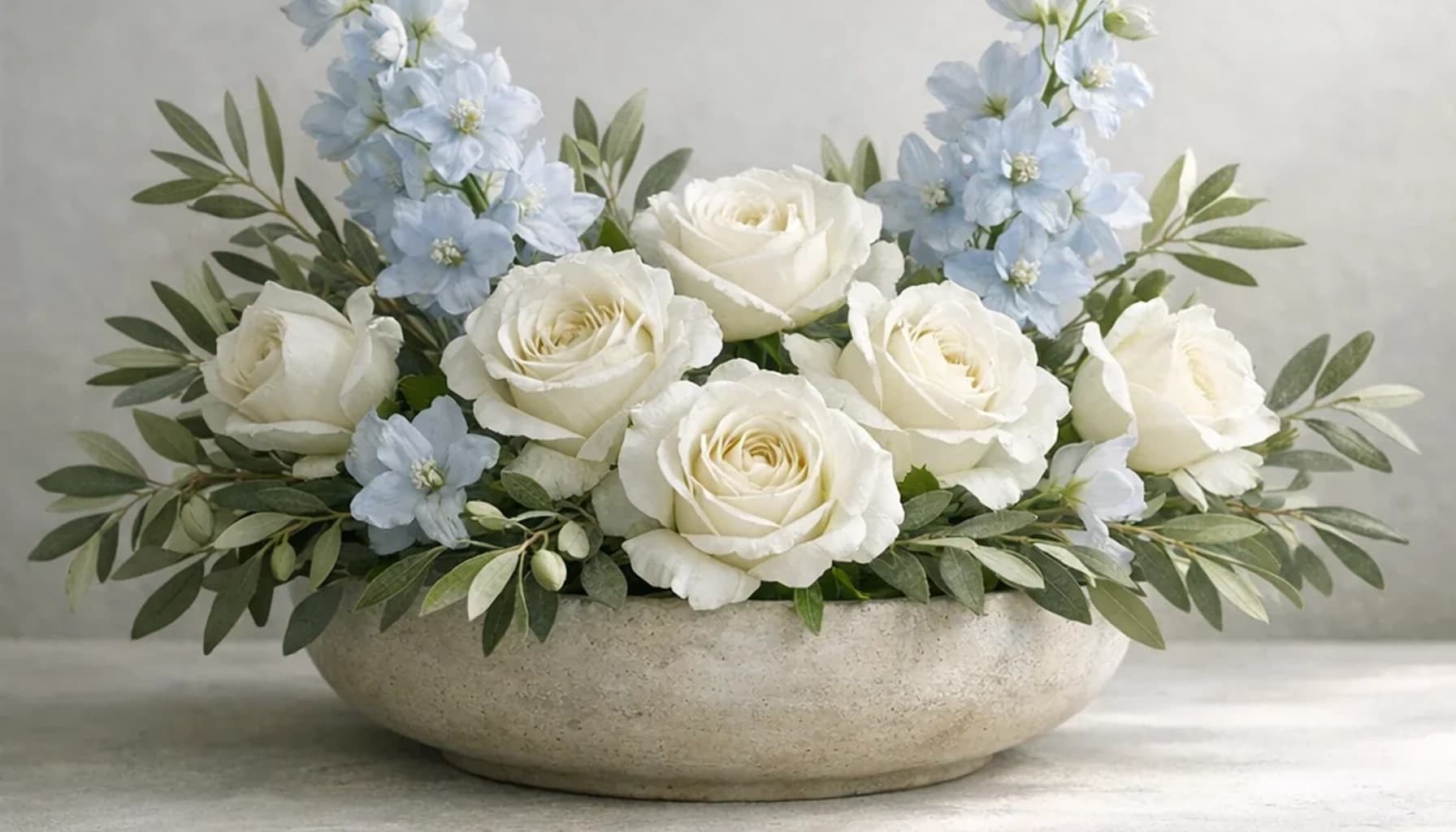 International Day of Non-Violence flower guide banner featuring white roses, olive branches, pale blue delphinium in white, olive, pale blue, stone tones