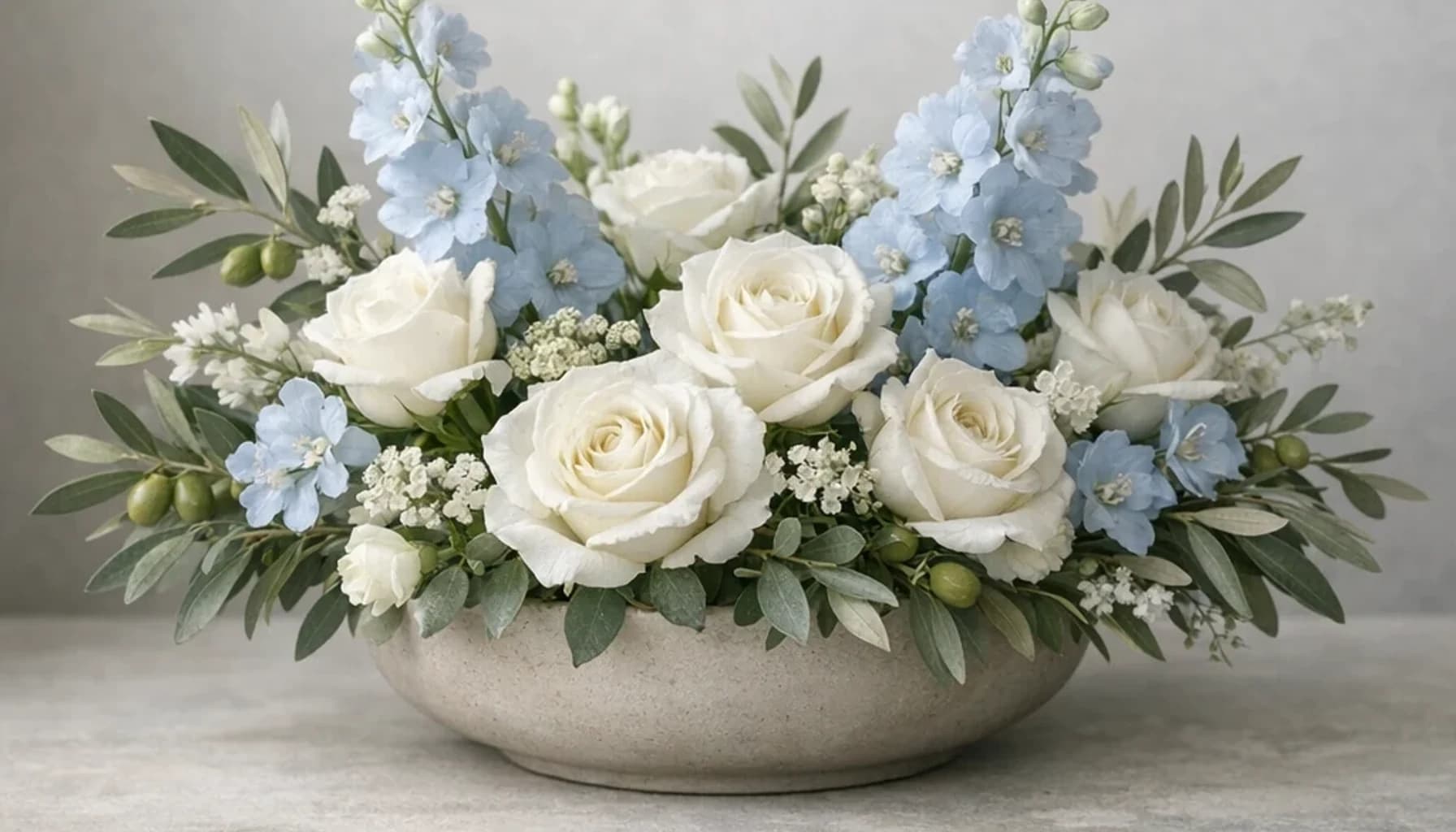 United Nations Day flower guide banner featuring white roses, olive branches, pale blue delphinium in white, olive, pale blue, stone tones