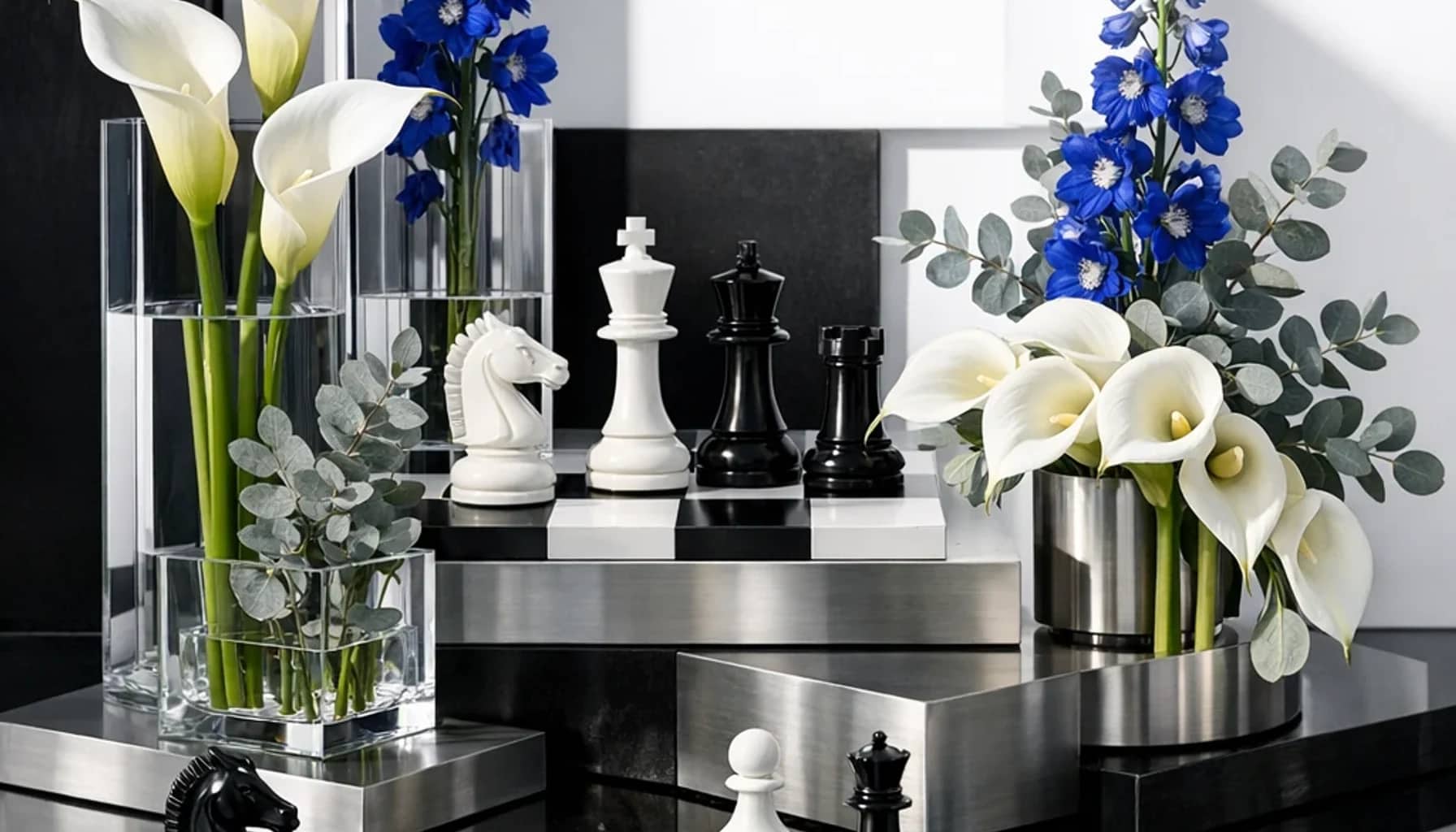 World Chess Day flower arrangement with white calla lilies, blue delphinium, silver eucalyptus designed as a respectful science and innovation floral guide