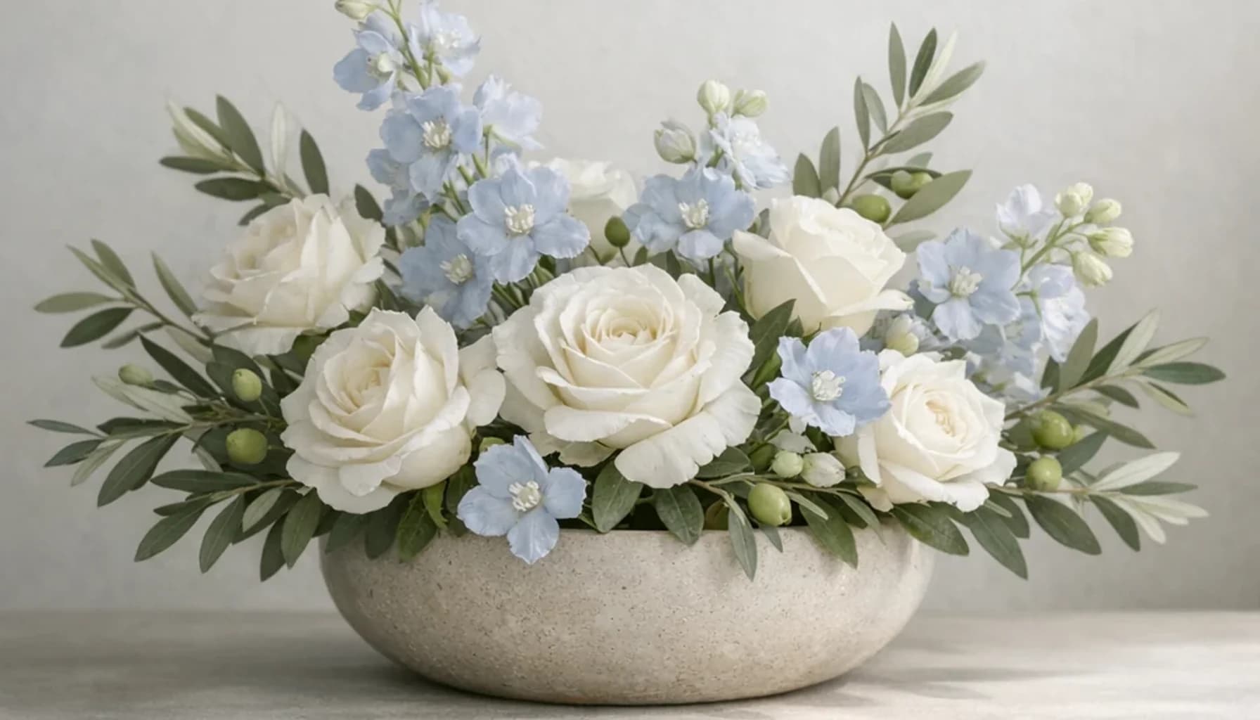 World Day of Social Justice flower guide banner featuring white roses, olive branches, pale blue delphinium in white, olive, pale blue, stone tones