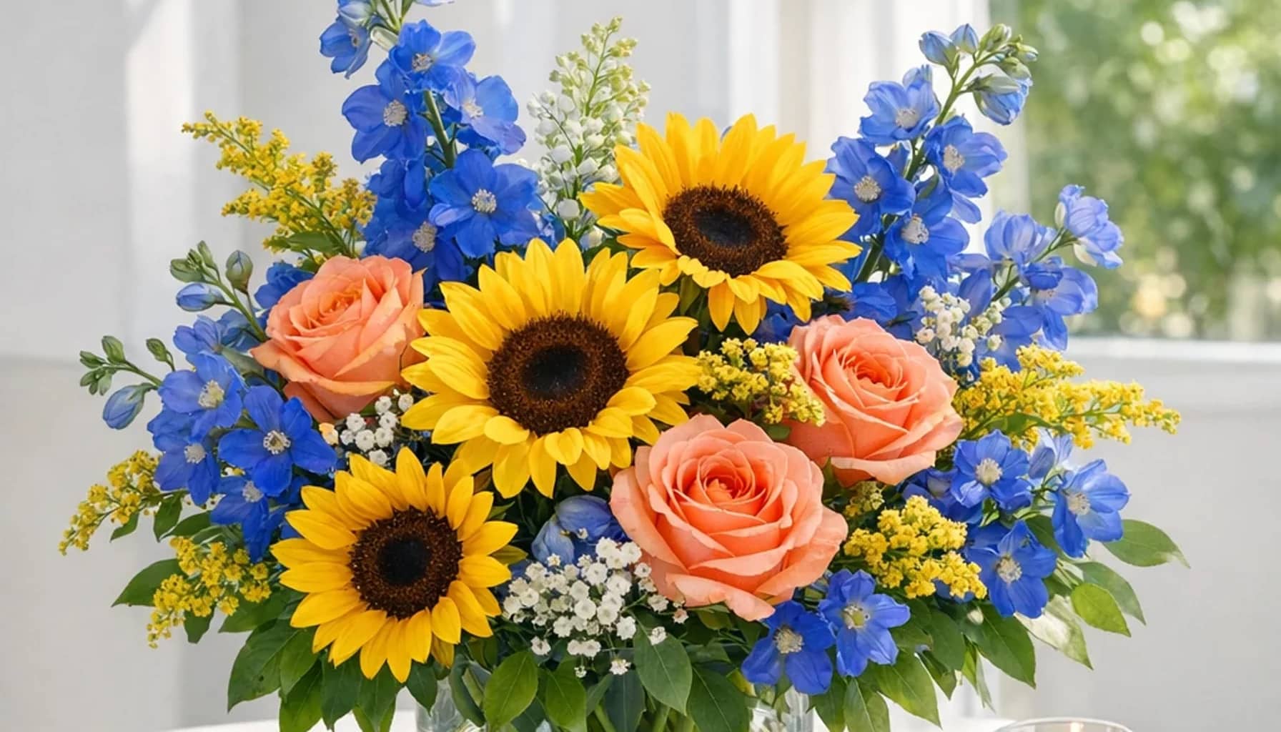 World Down Syndrome Day flower arrangement with sunflowers, coral roses, blue delphinium designed as a respectful community floral guide