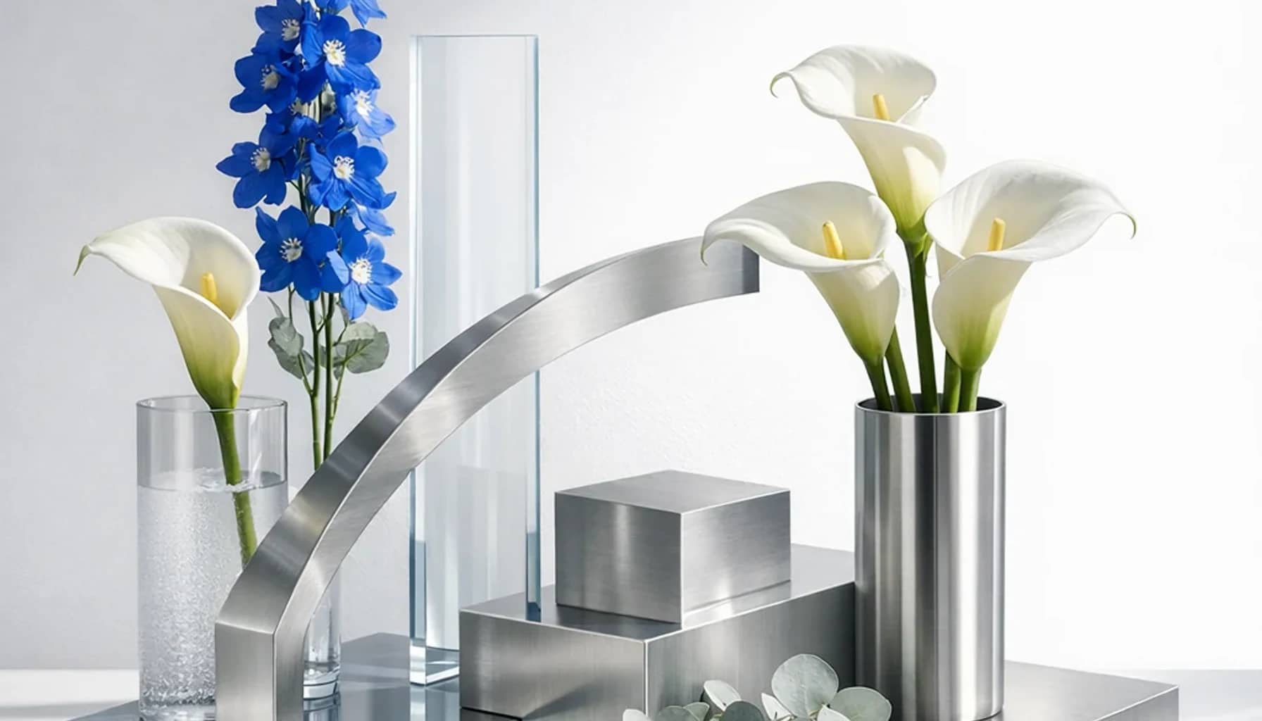 World Intellectual Property Day flower arrangement with white calla lilies, blue delphinium, silver eucalyptus designed as a respectful science and innovation floral guide