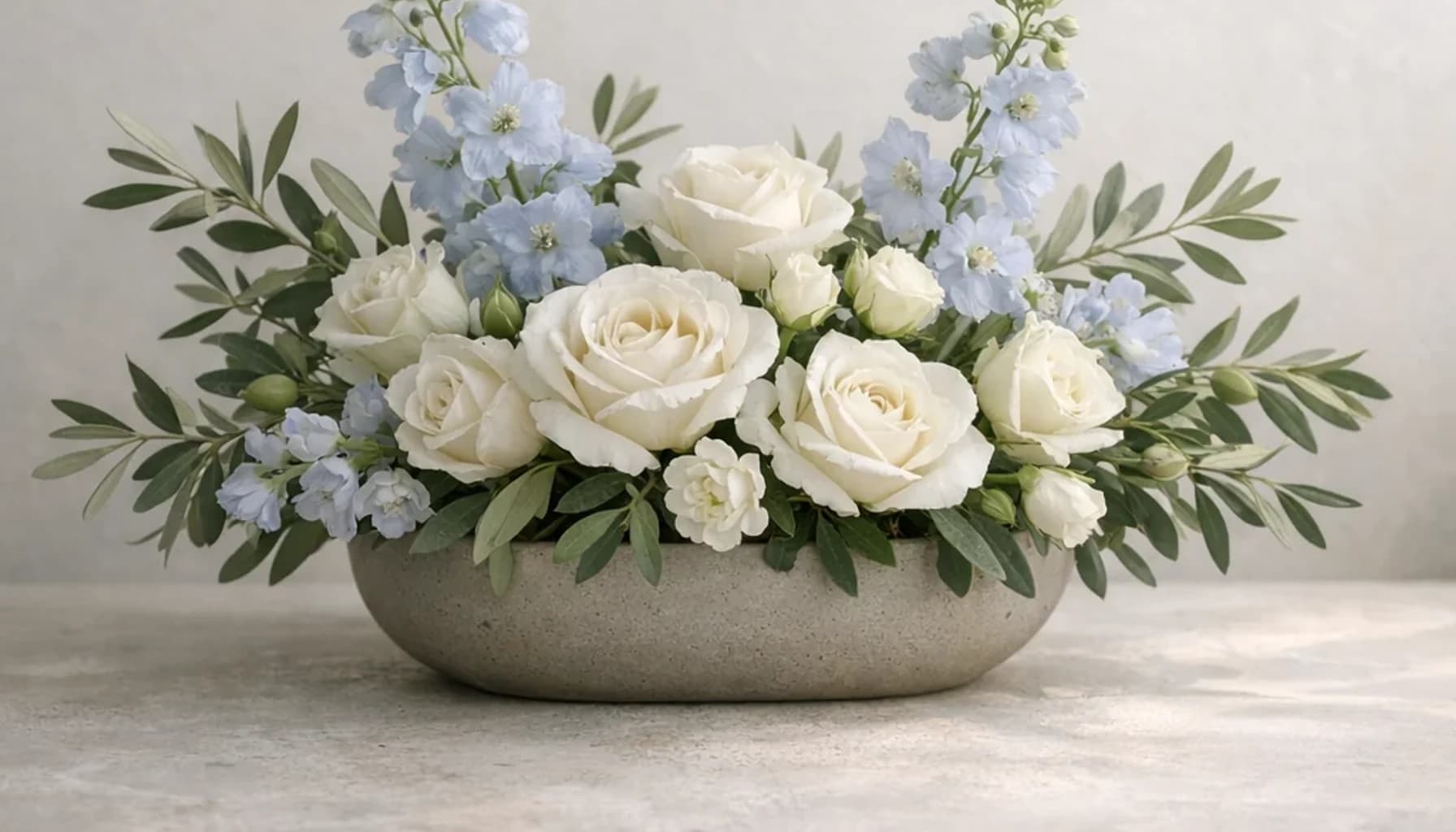 World Refugee Day flower guide banner featuring white roses, olive branches, pale blue delphinium in white, olive, pale blue, stone tones