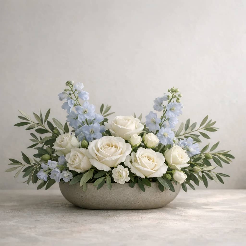 World Refugee Day floral calendar still life with white roses, olive branches, pale blue delphinium