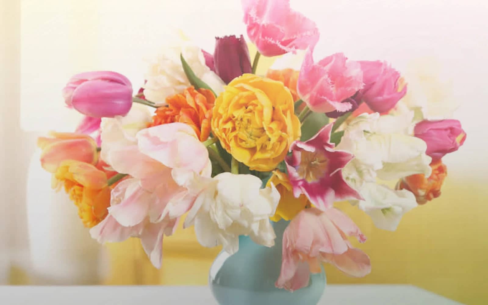 Daylight Saving Spring Forward flowers with tulips, ranunculus, and spray roses, soft lemon, pale pink, and fresh green color direction, and premium light, airy, optimistic, and longer-day styling from Lina Flowers