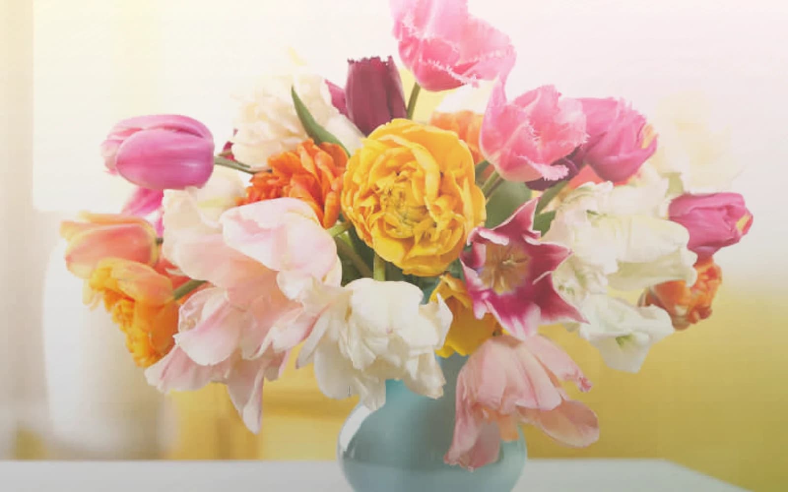 Daylight Saving Spring Forward flowers with tulips, ranunculus, and spray roses, soft lemon, pale pink, and fresh green color direction, and premium light, airy, optimistic, and longer-day styling from Lina Flowers