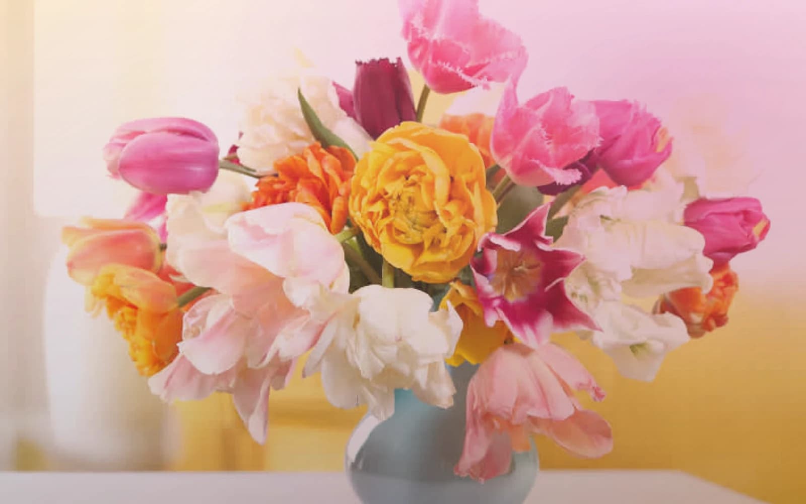Holi flowers with marigolds, magenta ranunculus, and orange roses, marigold yellow, festival magenta, and saffron orange color direction, and premium joyful, abundant, color-saturated, and spring-celebratory styling from Lina Flowers
