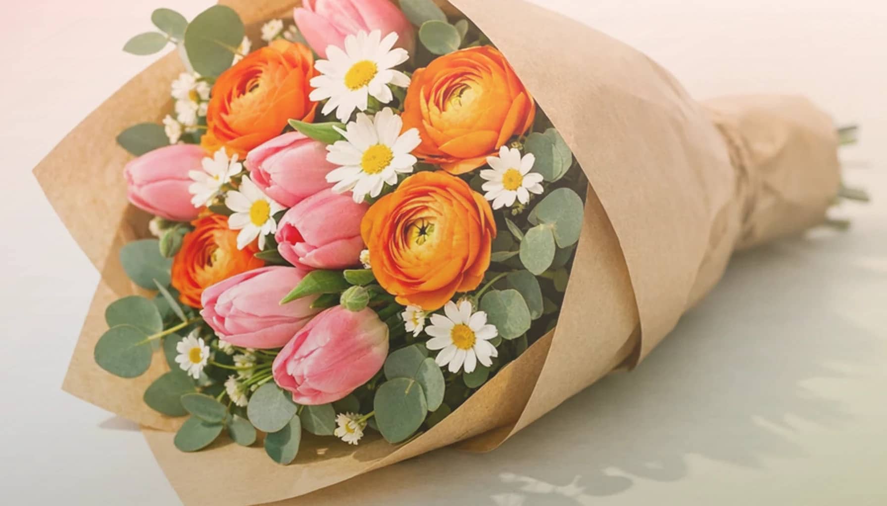 International Friendship Day flowers collection banner with coral garden roses, peach ranunculus, and soft yellow tulips and warm, generous, sincere, and friendship-led styling from Lina Flowers