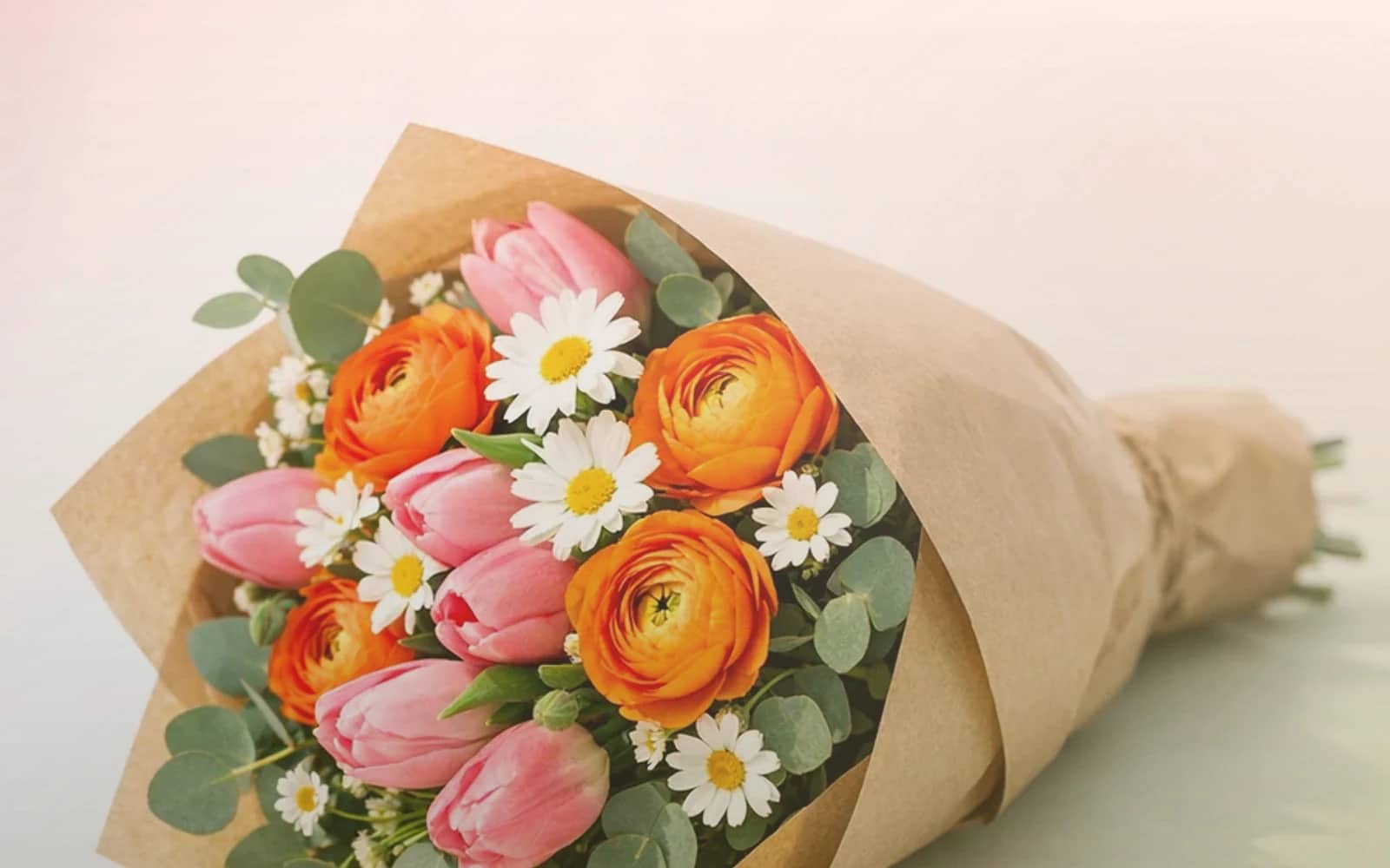 International Friendship Day flowers with coral garden roses, peach ranunculus, and soft yellow tulips, coral warmth, peach bloom, and soft yellow color direction, and premium warm, generous, sincere, and friendship-led styling from Lina Flowers