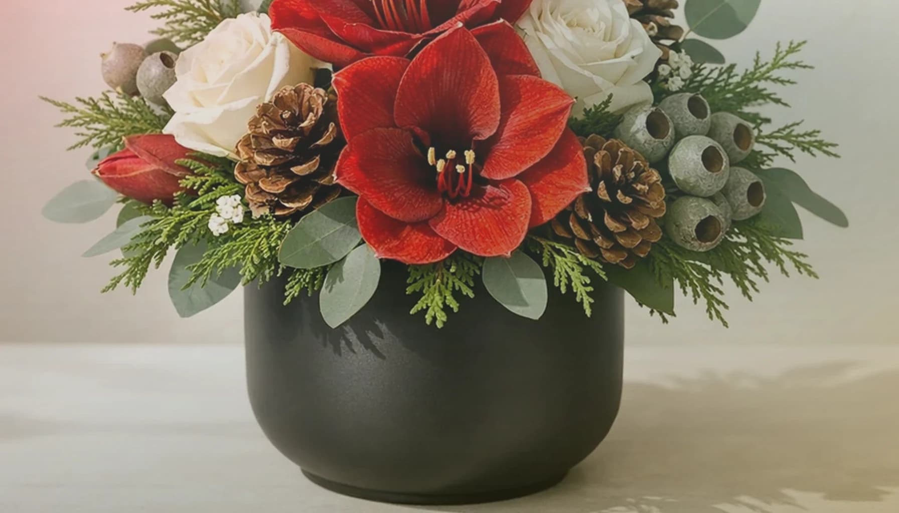 Las Posadas flowers collection banner with poinsettias, red garden roses, and evergreen branches and ceremonial, processional, warm, and respectfully traditional styling from Lina Flowers