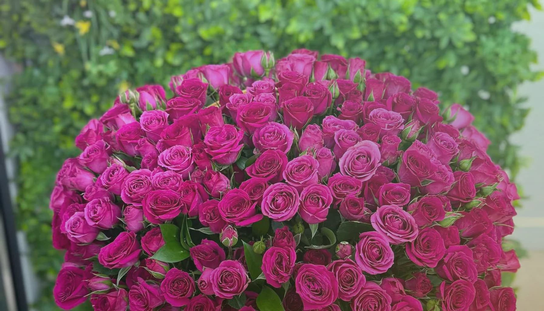 Mardi Gras flowers collection banner with purple lisianthus, green hellebores, and gold-toned roses and festive, jewel-toned, generous, and confident styling from Lina Flowers