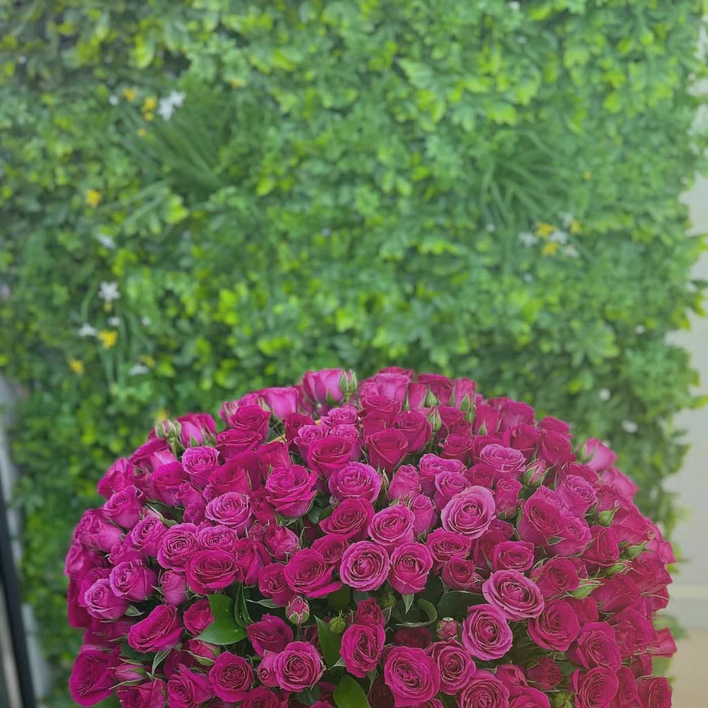 Mardi Gras flowers preview with purple lisianthus, green hellebores, and gold-toned roses in royal purple, parade green, and carnival gold tones from Lina Flowers