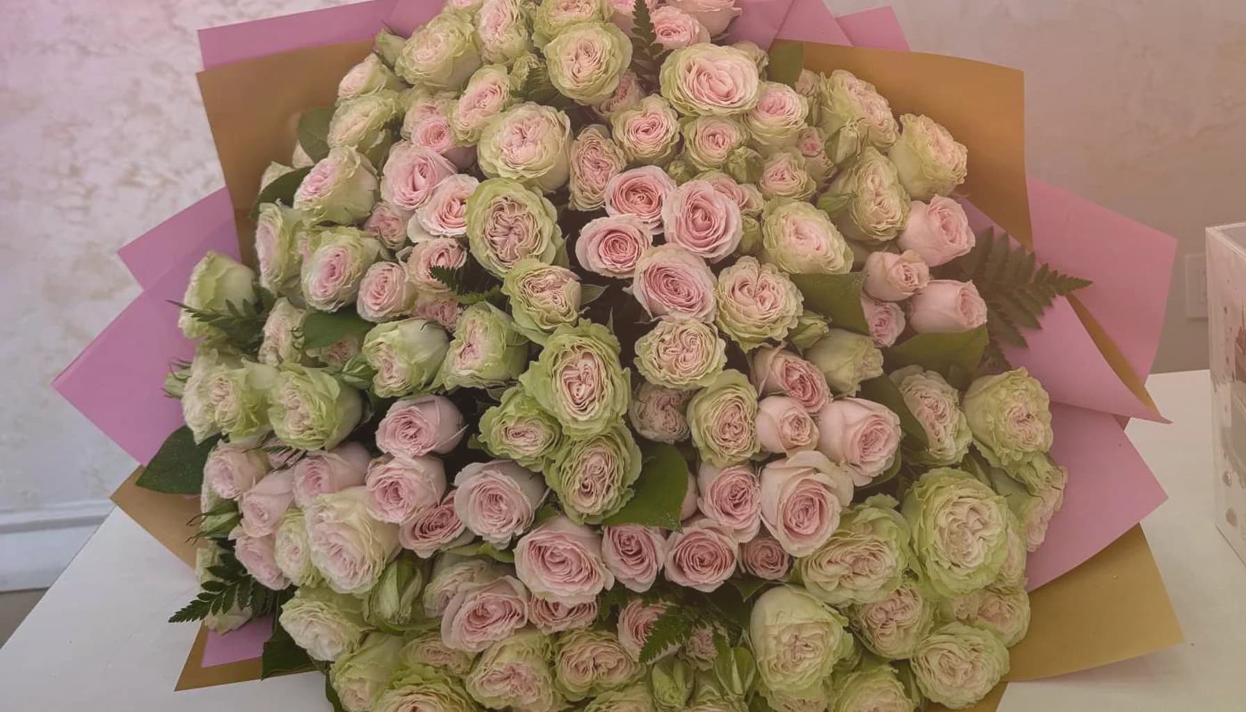 National Friendship Day flowers collection banner with pink garden roses, coral ranunculus, and sunny tulips and cheerful, generous, warmly summer, and friendship-led styling from Lina Flowers