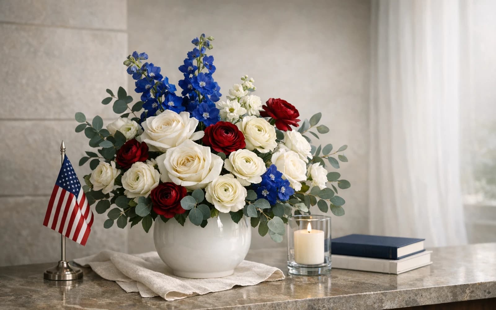 Presidents' Day flowers with white roses, blue delphinium, and ranunculus, winter white, navy bloom, and burgundy red color direction, and premium tailored, classic, composed, and winter-bright styling from LiNa Garden