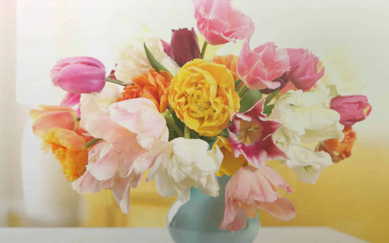 Tu BiShvat flowers with flowering quince, almond branches, and soft pink ranunculus, almond blossom, olive branch, and warm honey color direction, and premium renewing, branch-led, soft, and rooted styling from Lina Flowers