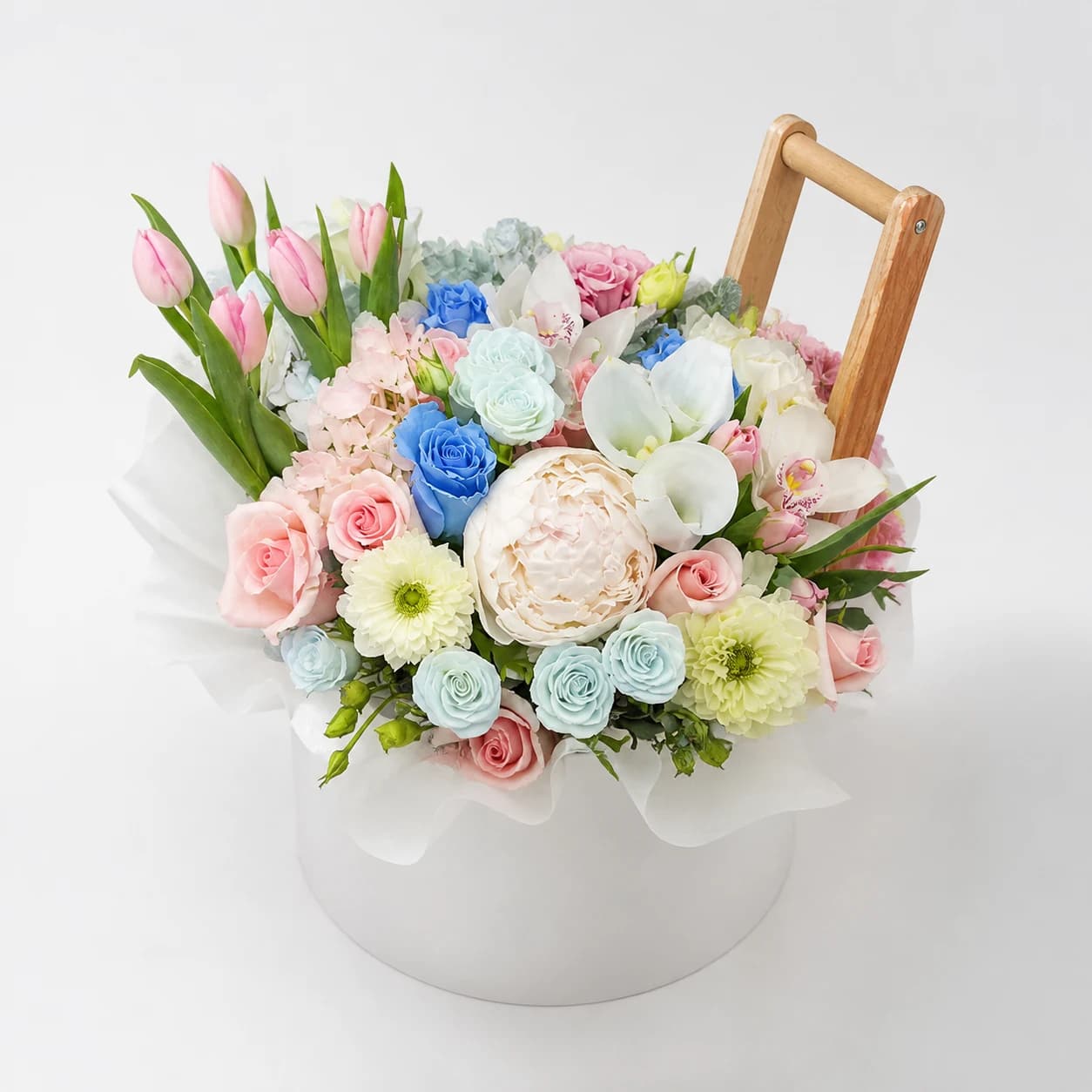 First Bloom AI-assisted studio view of the floral basket in soft pink, cream, pale yellow, and fresh white