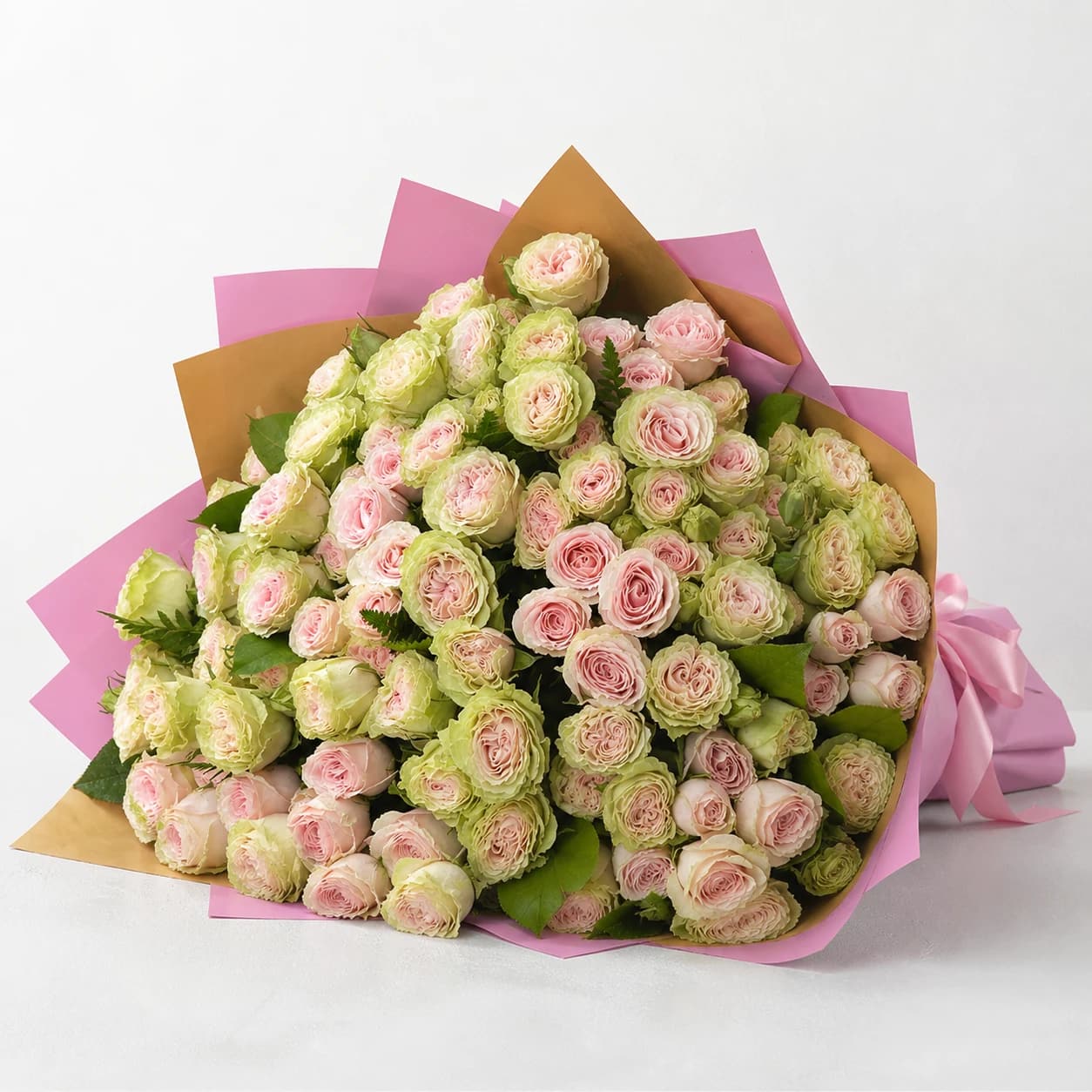 Friendship Garden AI-assisted studio view of the hand-wrapped bouquet in pink, yellow, lavender, white, and green