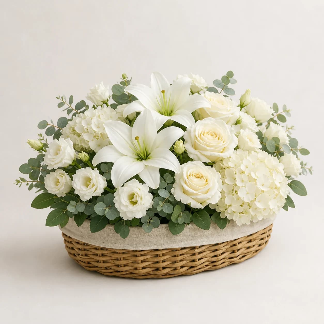 Graceful Tribute AI-assisted studio view of the floral basket in white, ivory, pale green, eucalyptus sage, and natural woven neutral