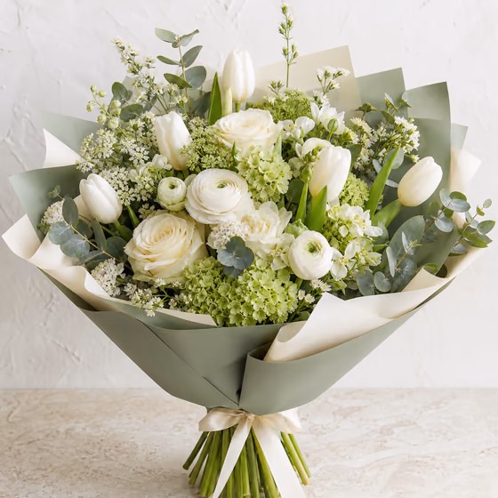 Fresh Start white and green bouquet with tulips, roses, ranunculus, hydrangea, and eucalyptus