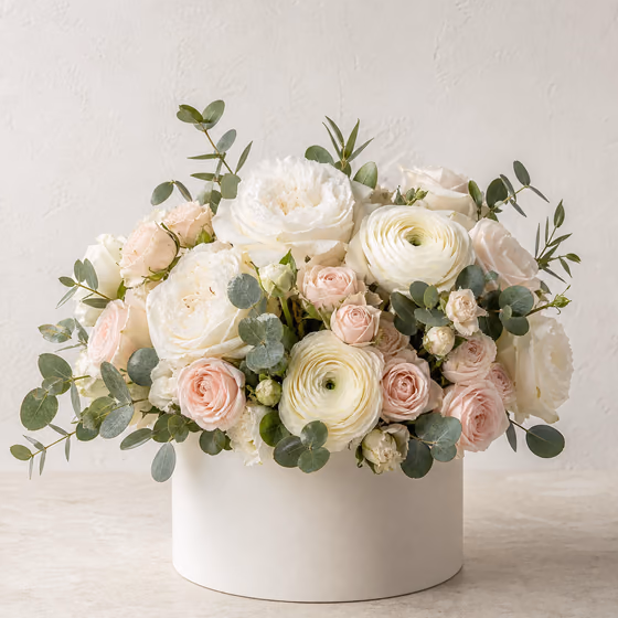 Ivory House white garden rose and cream ranunculus arrangement in a modern ivory flower box
